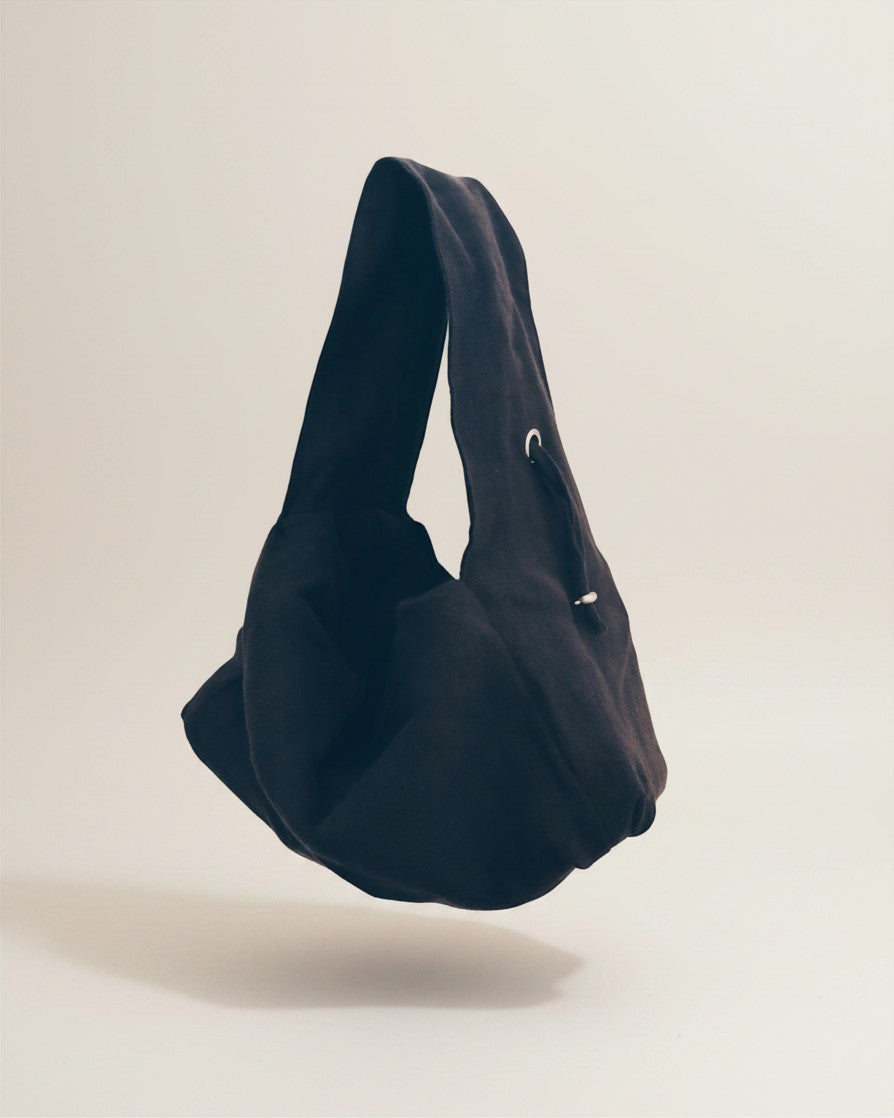 Hue Labs charcoal dumpling shoulder bag made from upcycled fabric with an adjustable strap and structured base.
