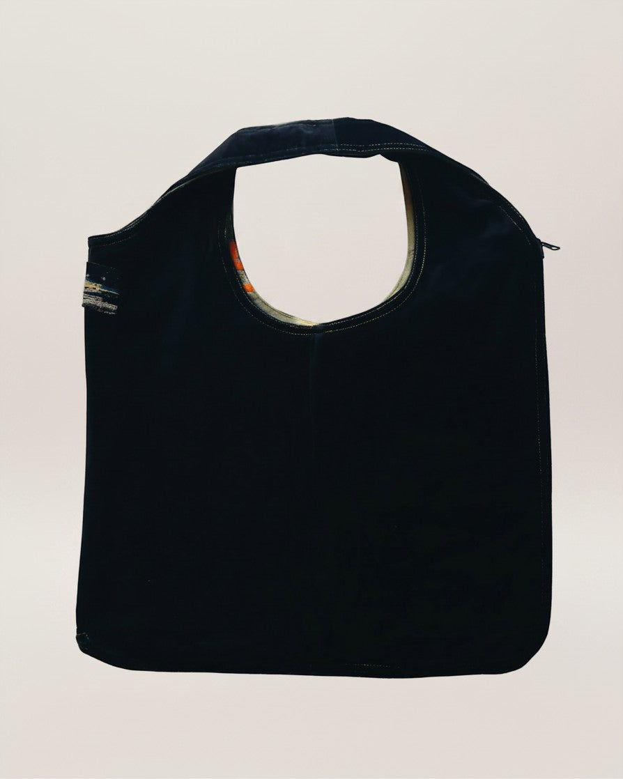 Hue Labs reversible Piña Colada vest bag in black, handcrafted from upcycled materials with a silver metal zipper.