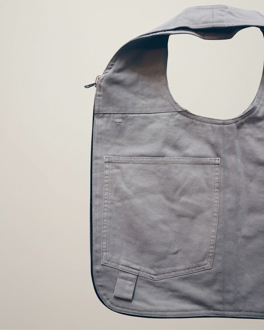 Hue Labs Ash Vest Bag in grey upcycled fabric with a front pocket and gun metal zipper detail