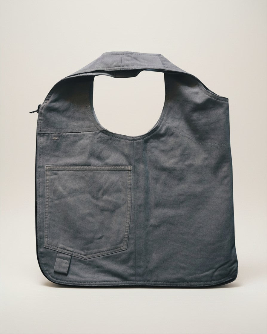 Hue Labs Ash Vest Bag in grey, a reversible handcrafted upcycled garment that functions as both a vest and a bag.