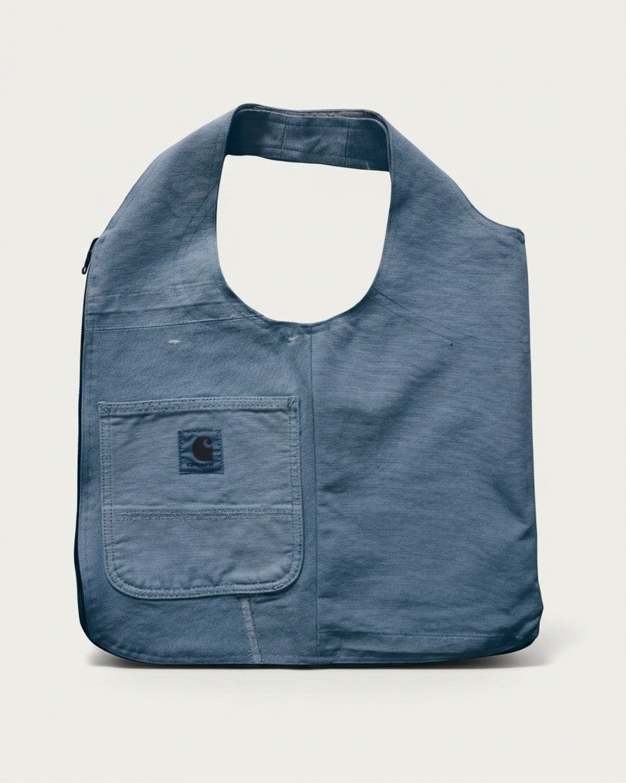 Hue Labs baby blue upcycled vest bag with a front pocket and gun metal zipper, versatile reversible design.