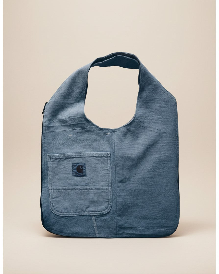 Hue Labs baby blue upcycled vest bag with a front pocket, featuring a versatile reversible design and metal zipper.