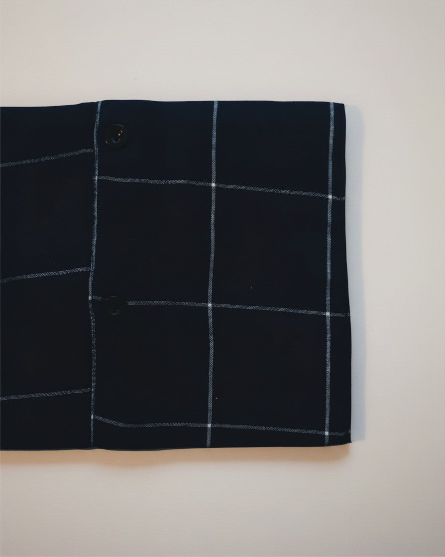 Hue Labs blue envelope bag featuring a white grid pattern made from sustainable upcycled textiles.