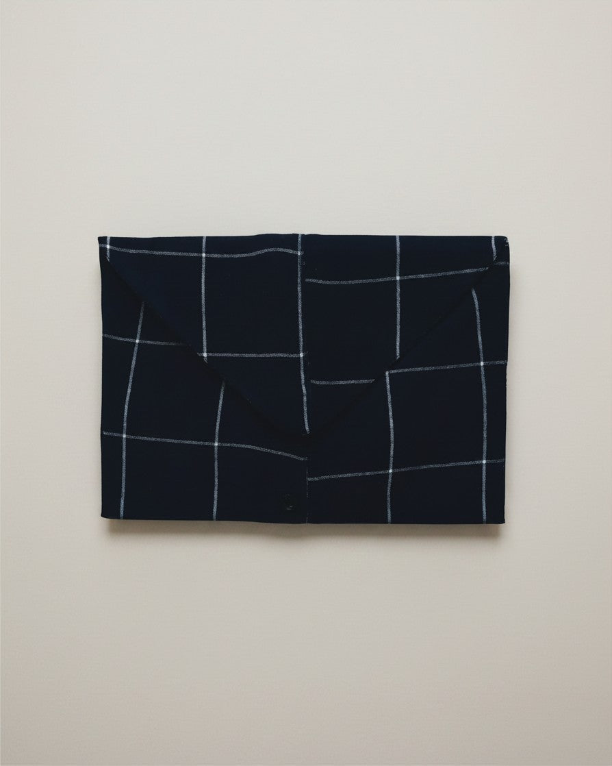 Hue Labs blue envelope clutch bag featuring a white checkered pattern, crafted from sustainable upcycled textiles.