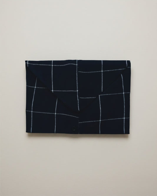 Hue Labs blue envelope clutch bag featuring a white checkered pattern, crafted from sustainable upcycled textiles.