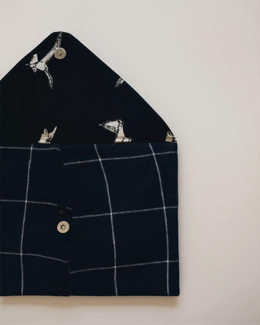 Hue Labs blue checkered envelope clutch made from upcycled textiles with a bird-patterned interior lining