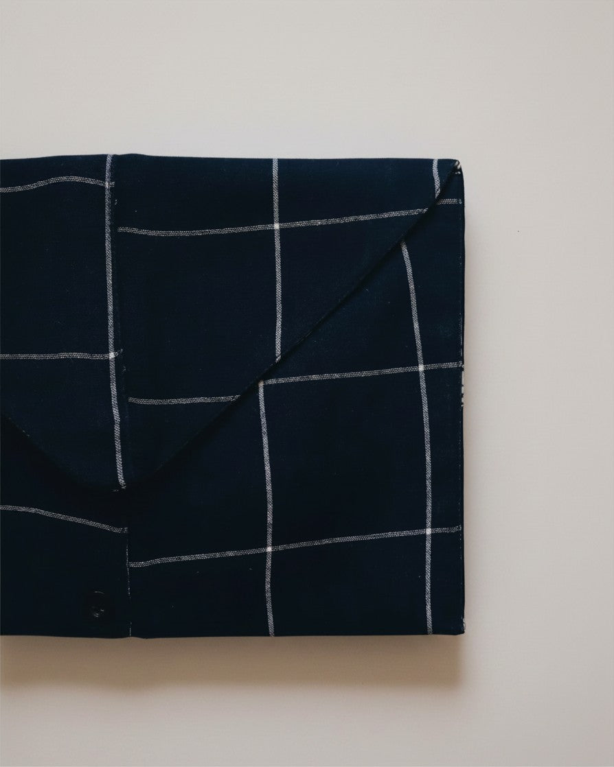 Hue Labs blue envelope clutch bag with a white checkered pattern, crafted from sustainable upcycled textiles.