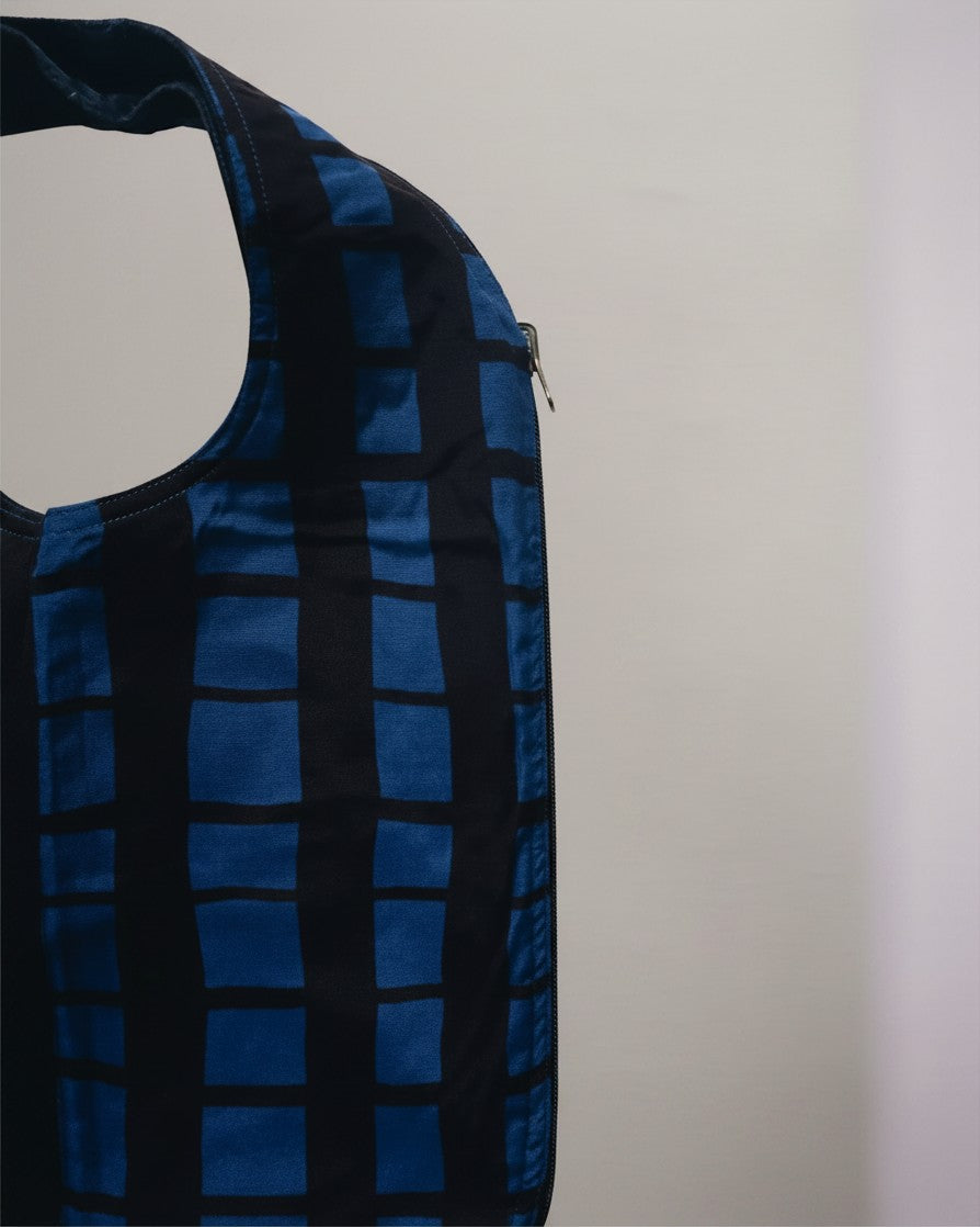 Hue Labs reversible blue grid vest bag made from upcycled materials with a gun metal silver zipper