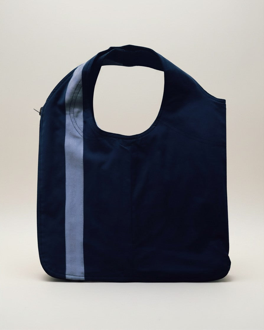 Hue Labs reversible blue vest bag with a light blue stripe, handcrafted from upcycled materials with a metal zipper.