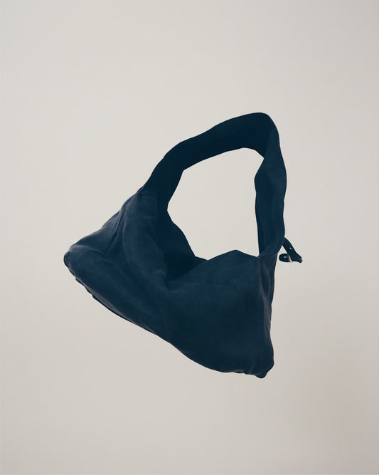 Hue Labs charcoal dumpling shoulder bag made from upcycled fabric with an adjustable strap and structured base.