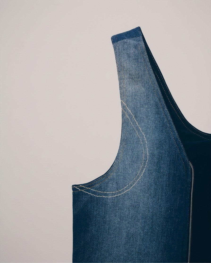 Hue Labs reversible medium wash denim vest bag featuring a durable gun metal silver zipper and upcycled fabric