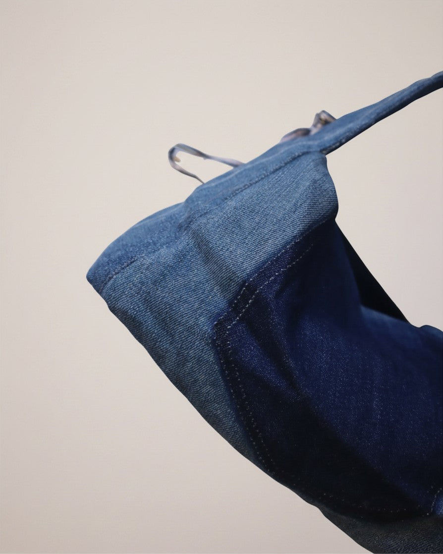 Hue Labs midnight blue distressed denim dumpling shoulder bag with adjustable strap and sturdy base