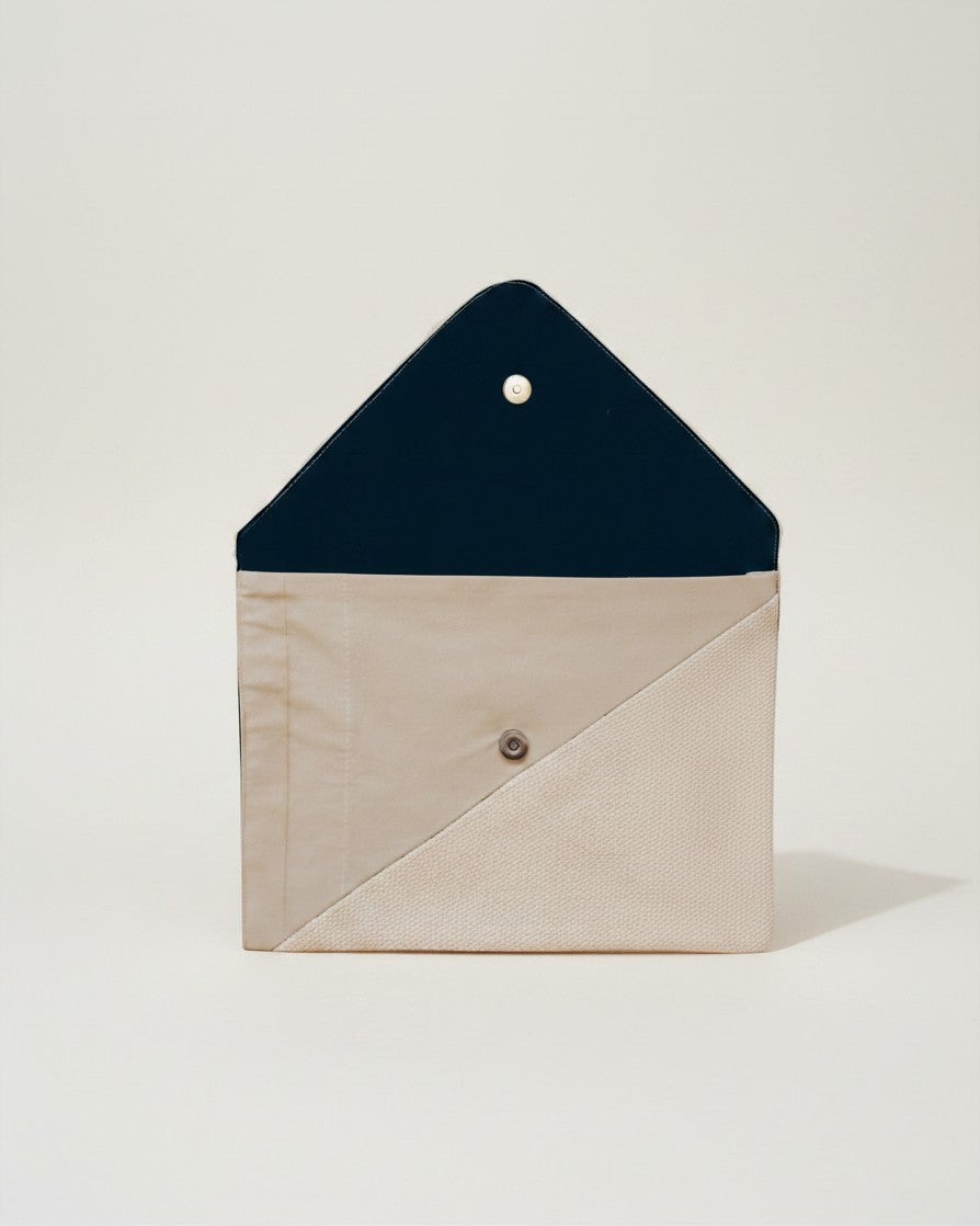 Hue Labs Earth Tones III envelope clutch in beige and dark blue upcycled textile with a magnetic snap closure.