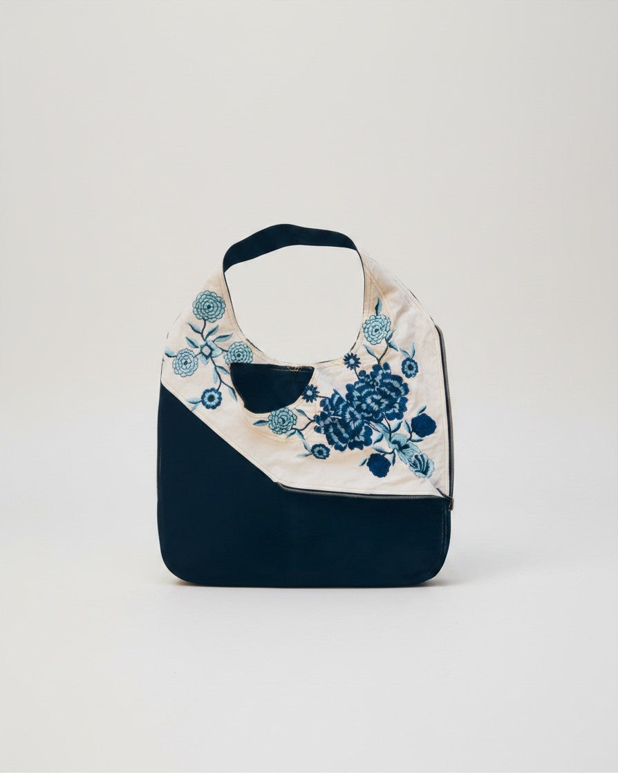 Hue Labs reversible vest bag in navy and cream with blue floral embroidery, handcrafted from upcycled materials.