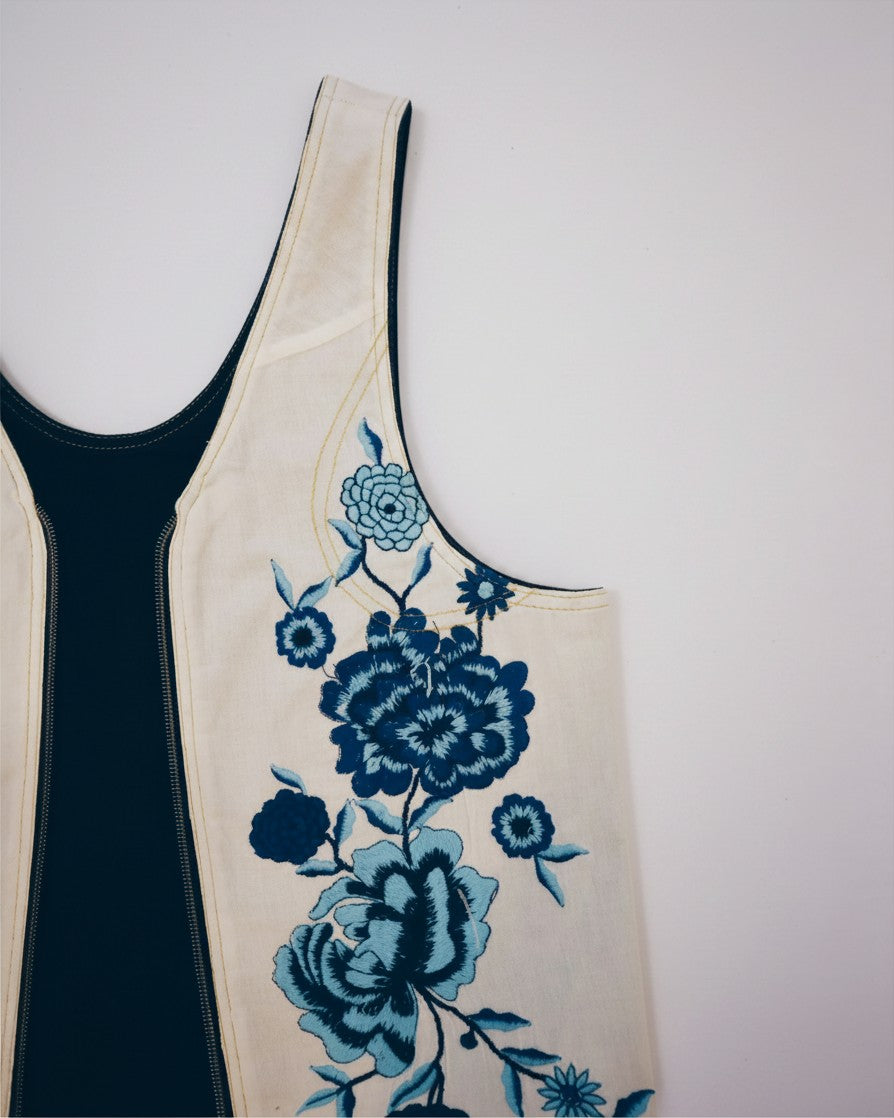 Hue Labs Floral Dreams reversible vest bag in cream and dark blue with intricate floral embroidery and silver zipper
