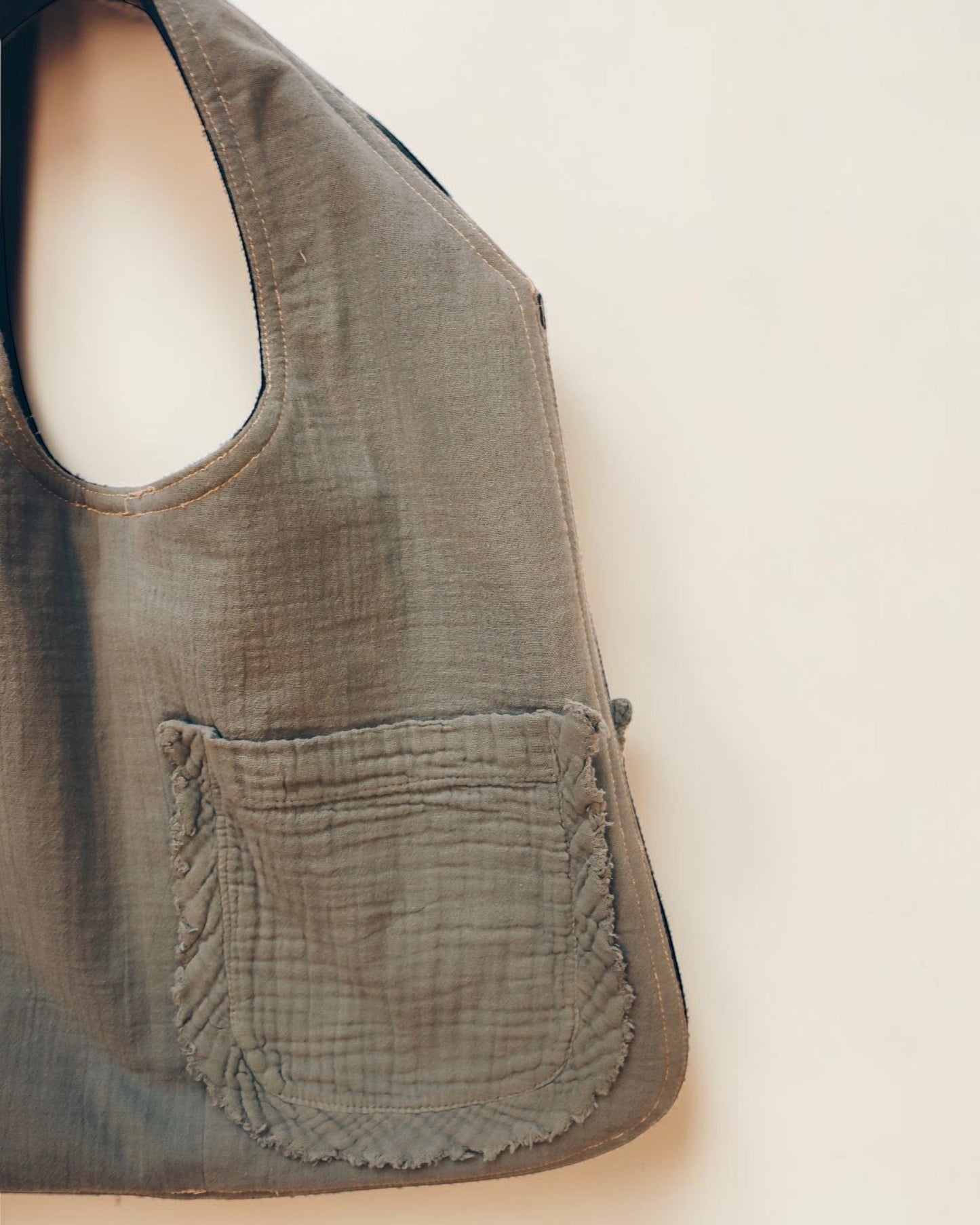 Hue Labs reversible Garden Vest Bag in sage green upcycled fabric with a front pocket and gun metal zipper.
