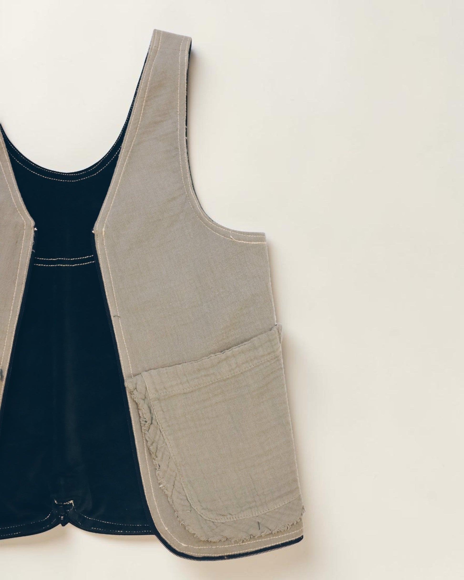 Hue Labs reversible Garden Vest Bag in beige and black upcycled fabric with a gun metal zipper.