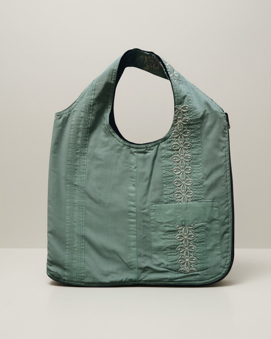 Hue Labs green floral upcycled vest bag with a gun metal zipper and embroidered pocket detail