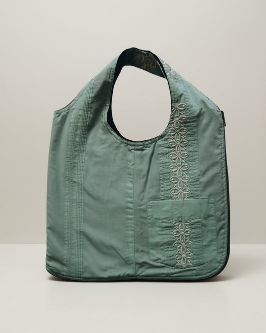 Hue Labs green floral upcycled vest bag with a gun metal zipper and embroidered pocket detail