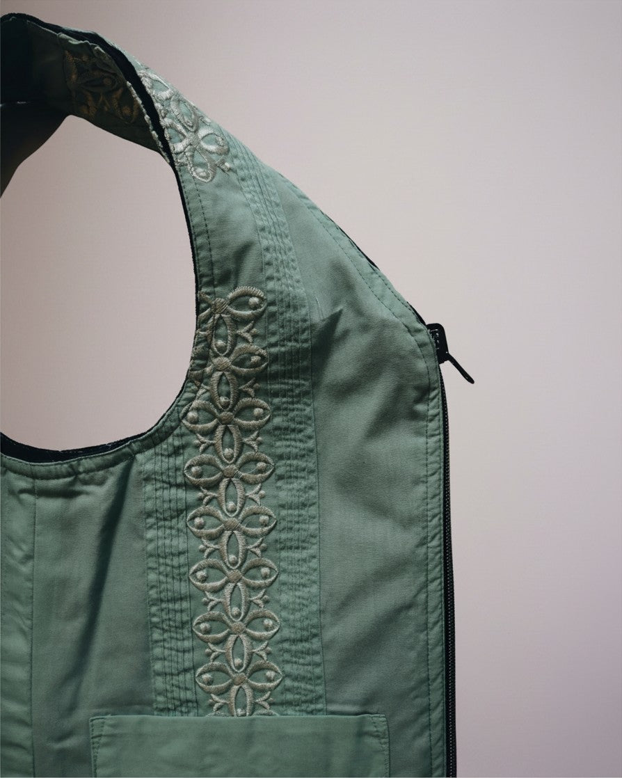 Hue Labs green floral upcycled vest bag with intricate embroidery and a gun metal silver zipper detail.