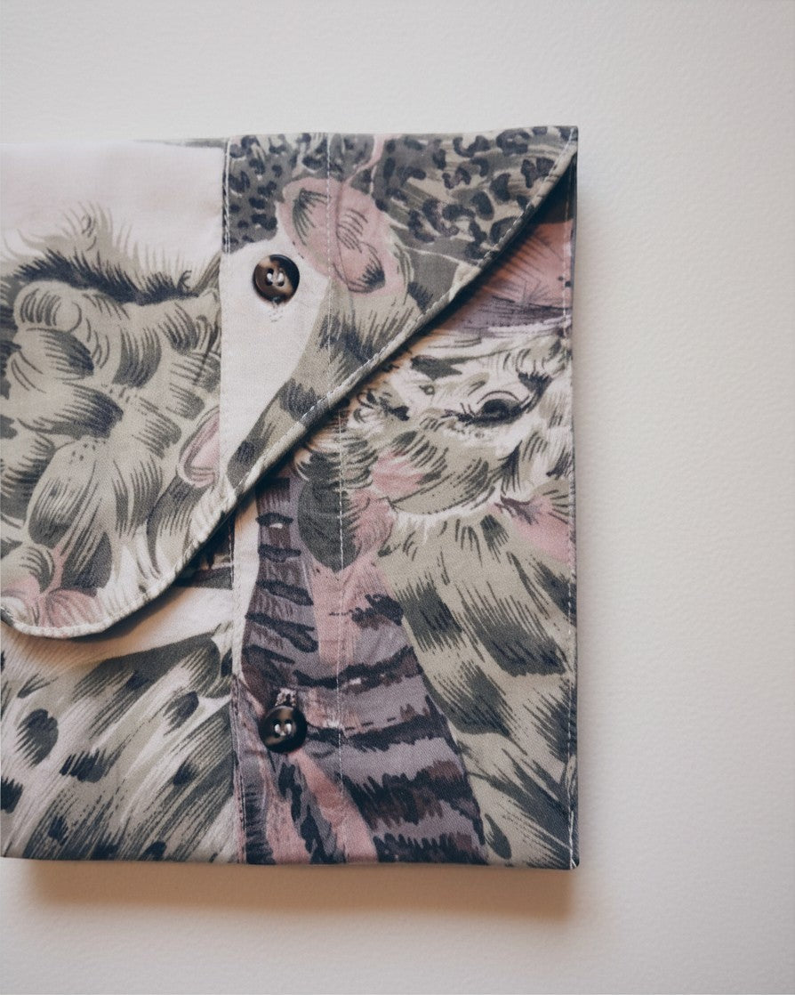 Hue Labs Jungle Envelope Clutch made from upcycled textile with a patterned animal print and magnetic snap closure.