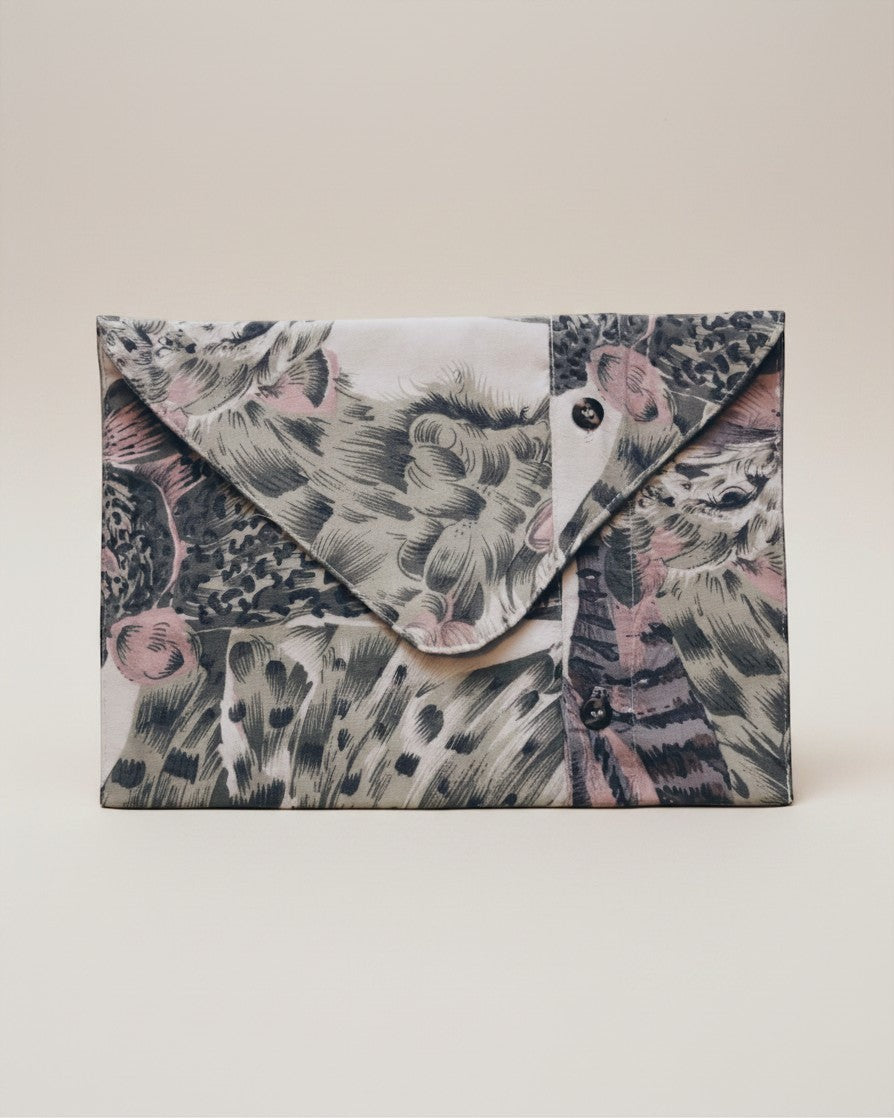 Hue Labs Jungle envelope clutch in upcycled fabric with a patterned animal print and magnetic snap closure