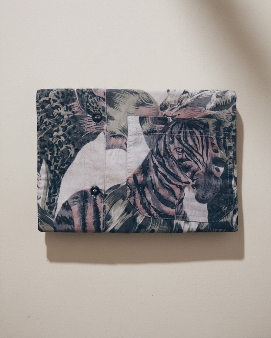 Hue Labs Jungle Envelope Clutch in upcycled textile with a multi-colored animal print and magnetic snap closure.