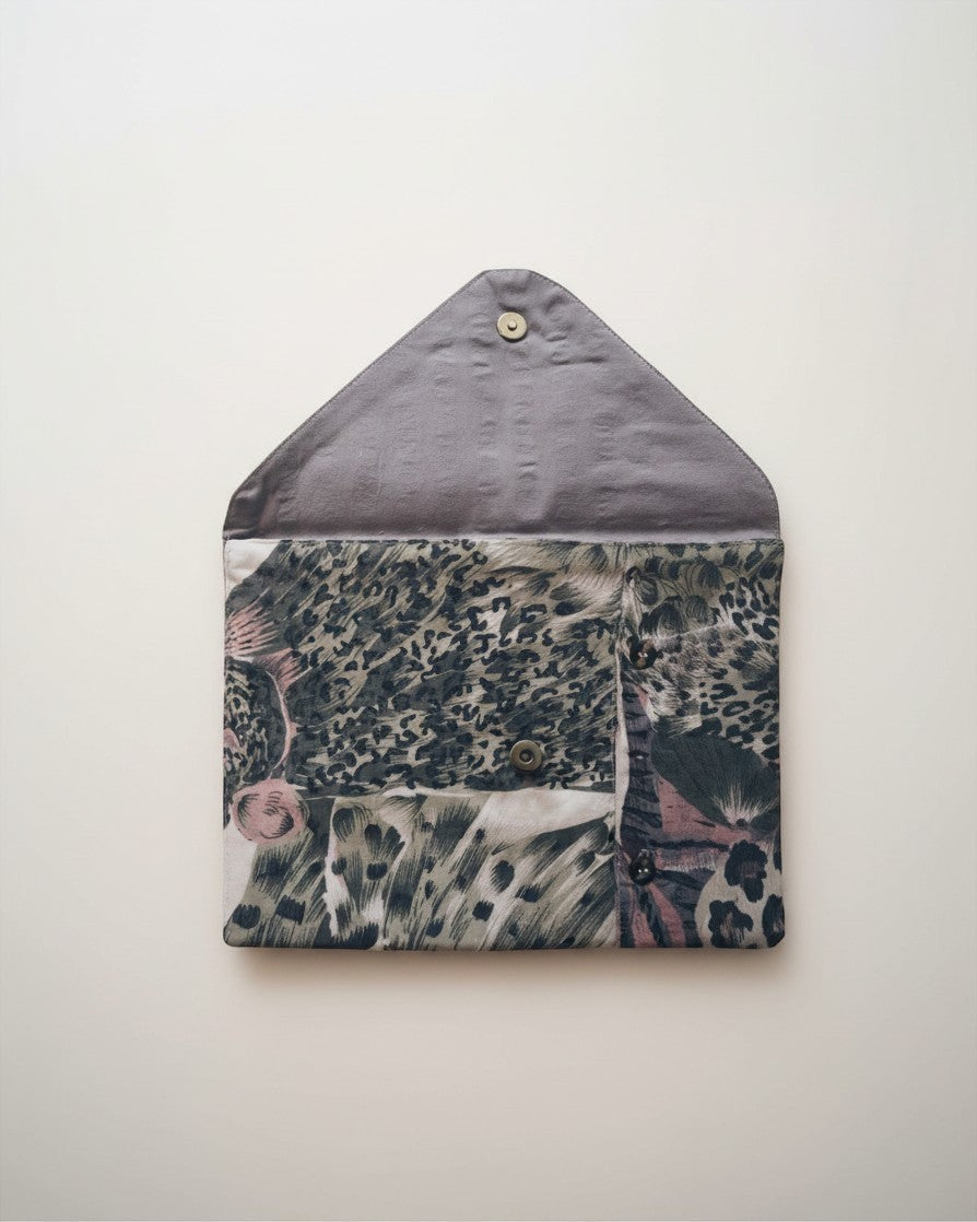Hue Labs Jungle envelope clutch in upcycled textile with a grey animal print pattern and magnetic snap closure.
