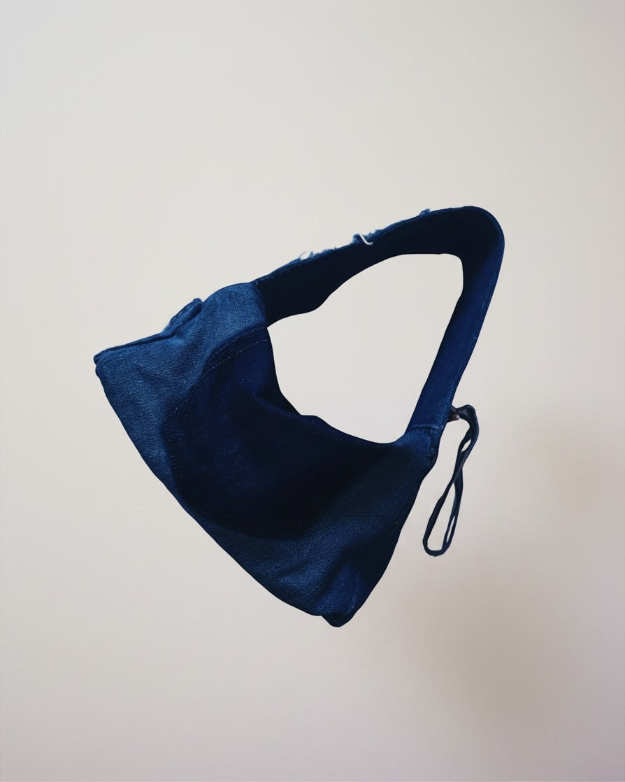 Hue Labs midnight blue distressed dumpling shoulder bag made from upcycled fabric with an adjustable strap.