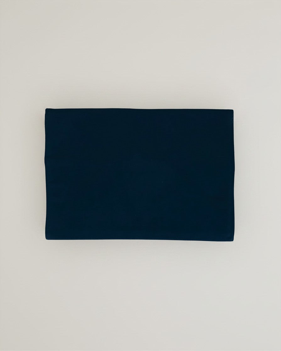 Hue Labs midnight blue envelope clutch made from upcycled cotton with a minimalist design on a neutral background.