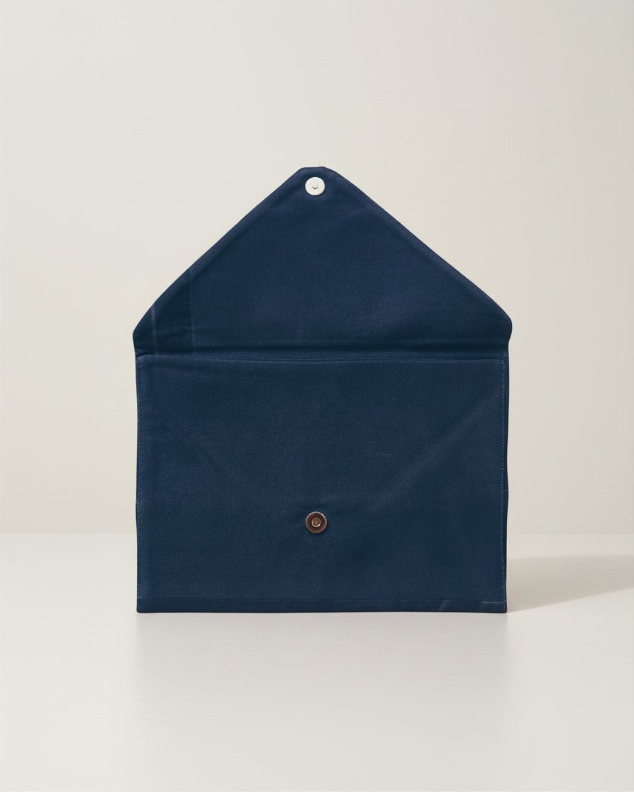 Hue Labs Midnight Envelope Clutch in dark blue upcycled cotton with a magnetic snap closure, shown open.