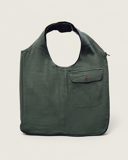 Hue Labs olive green upcycled vest bag with a front pocket and gun metal zipper, designed for reversible versatility.