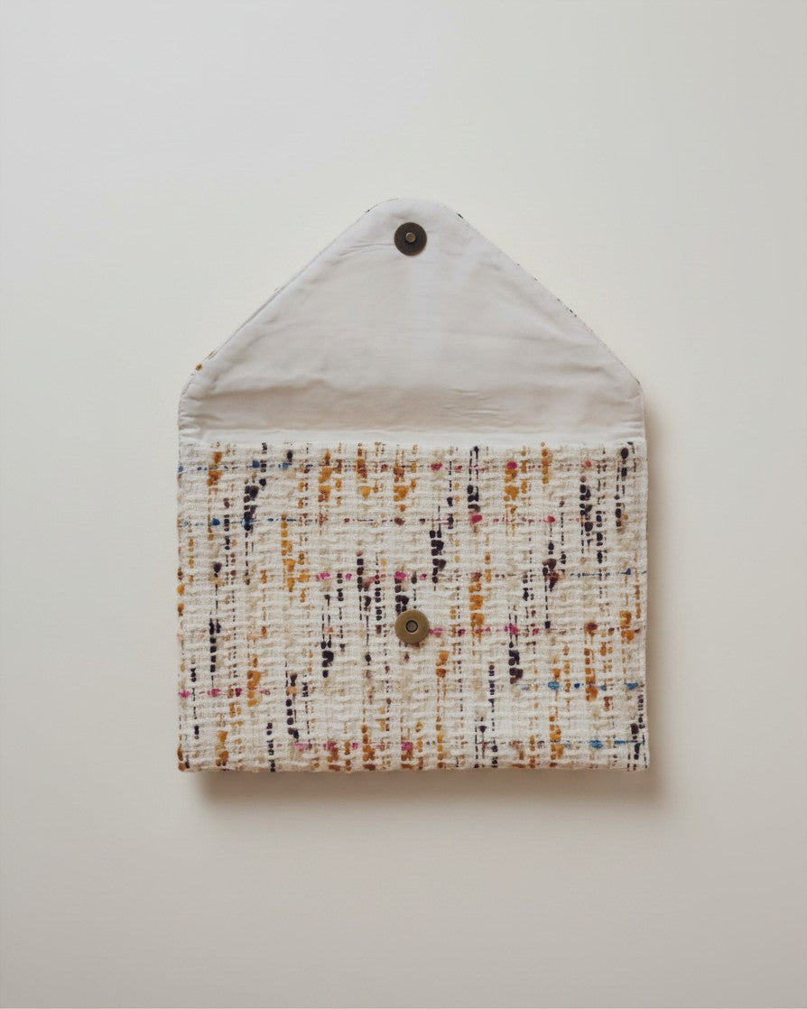 Hue Labs Popsicle envelope clutch in textured upcycled fabric with a magnetic snap closure, shown open.