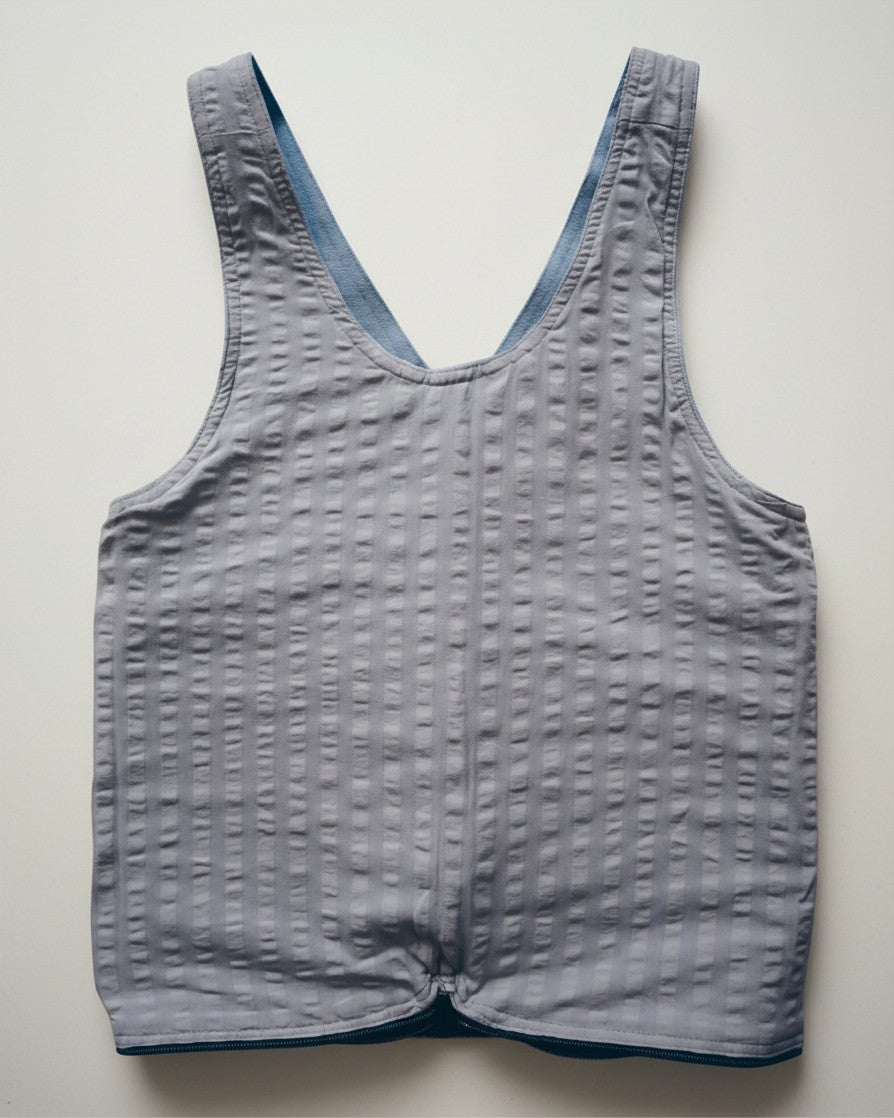 Hue Labs reversible baby blue vest bag made from upcycled textured fabric with a gun metal zipper.