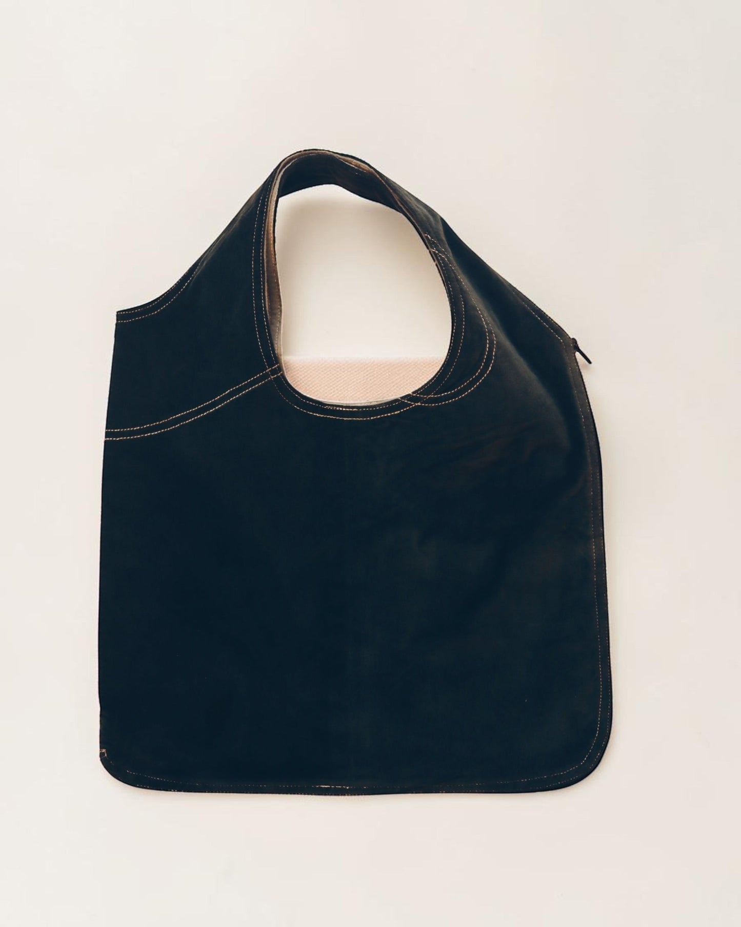 Hue Labs reversible Garden Vest Bag in black upcycled material with contrast stitching and gun metal zipper detail.