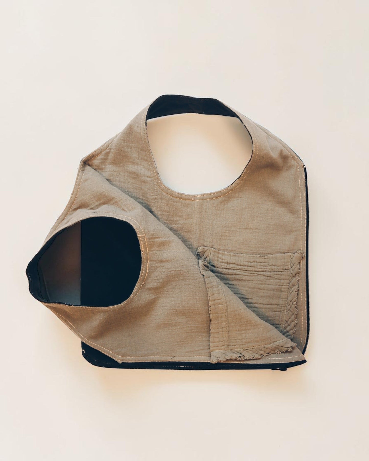 Hue Labs reversible Garden Vest Bag in beige upcycled fabric with a gun metal zipper, versatile wearable accessory.