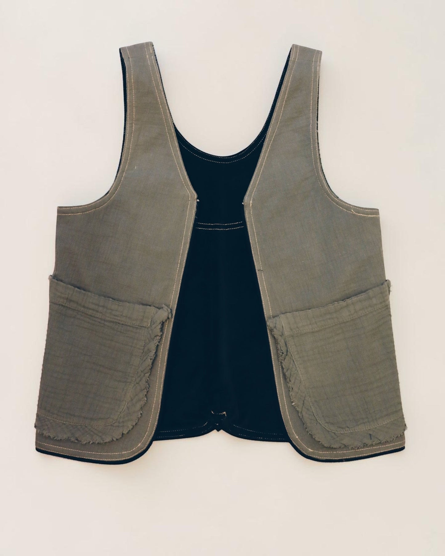 Hue Labs reversible upcycled Garden Vest Bag in olive green and black with large front pockets and metal zipper.