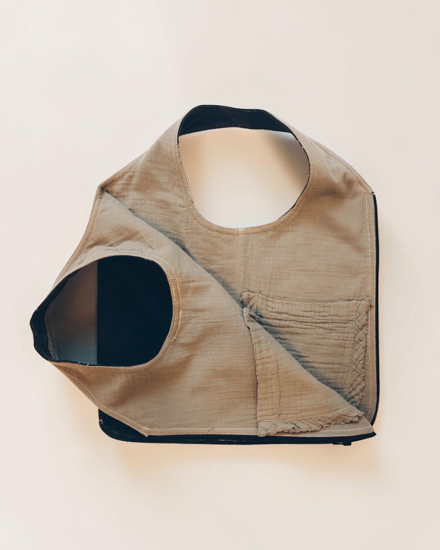 Hue Labs reversible Garden Vest Bag in beige and black upcycled fabric with a gun metal zipper.