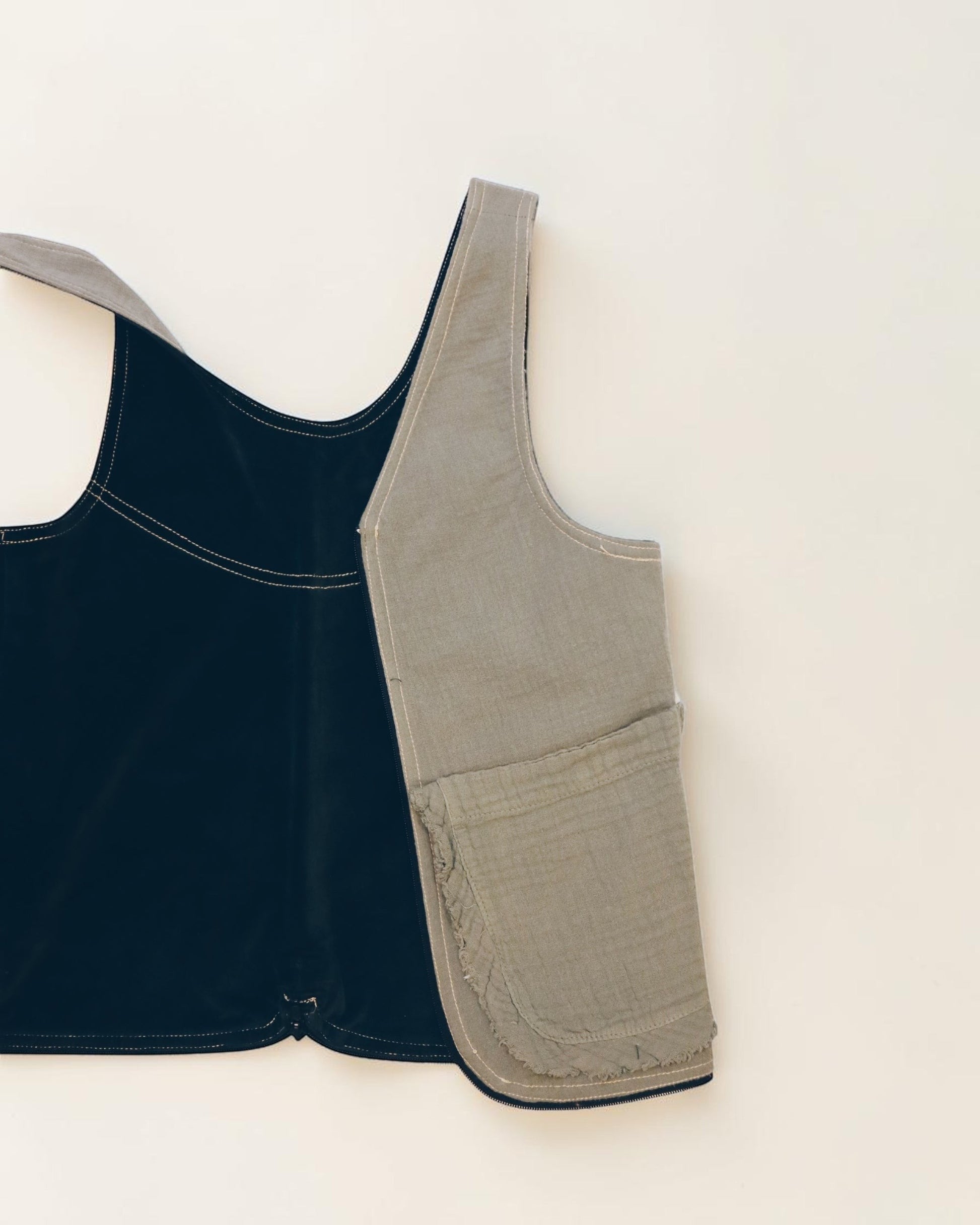 Hue Labs reversible Garden Vest Bag in black and olive green upcycled fabric with a functional front pocket.