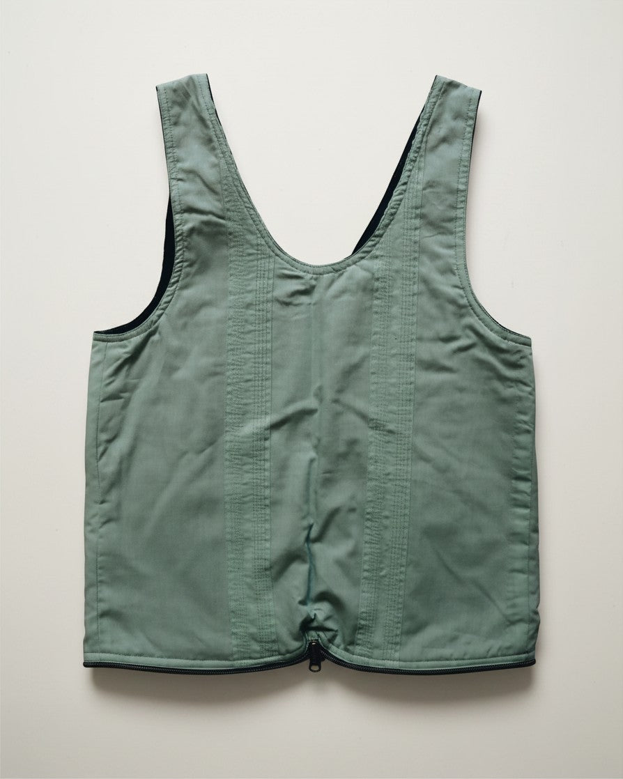 Hue Labs reversible green vest bag made from upcycled materials with a gun metal silver zipper