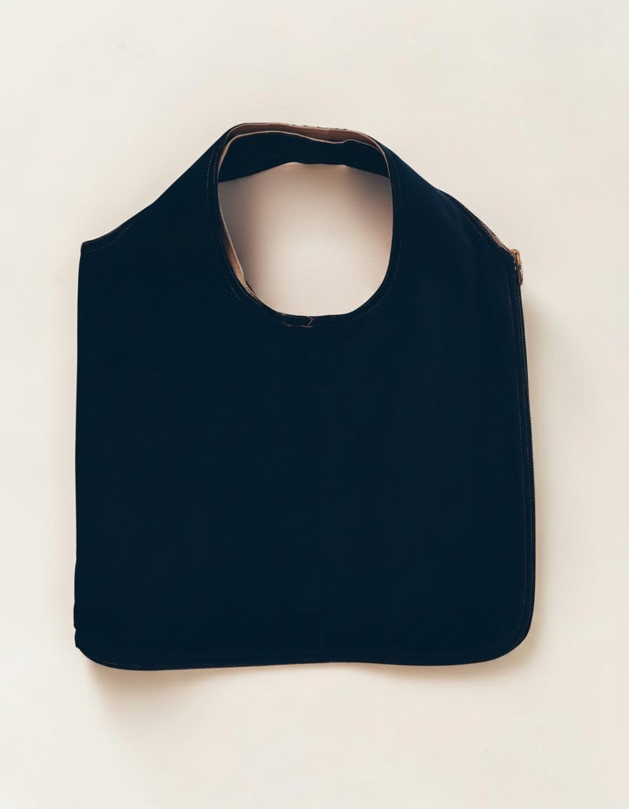 Hue Labs reversible upcycled vest bag in dark navy, featuring a gun metal zipper and versatile dual-use design.