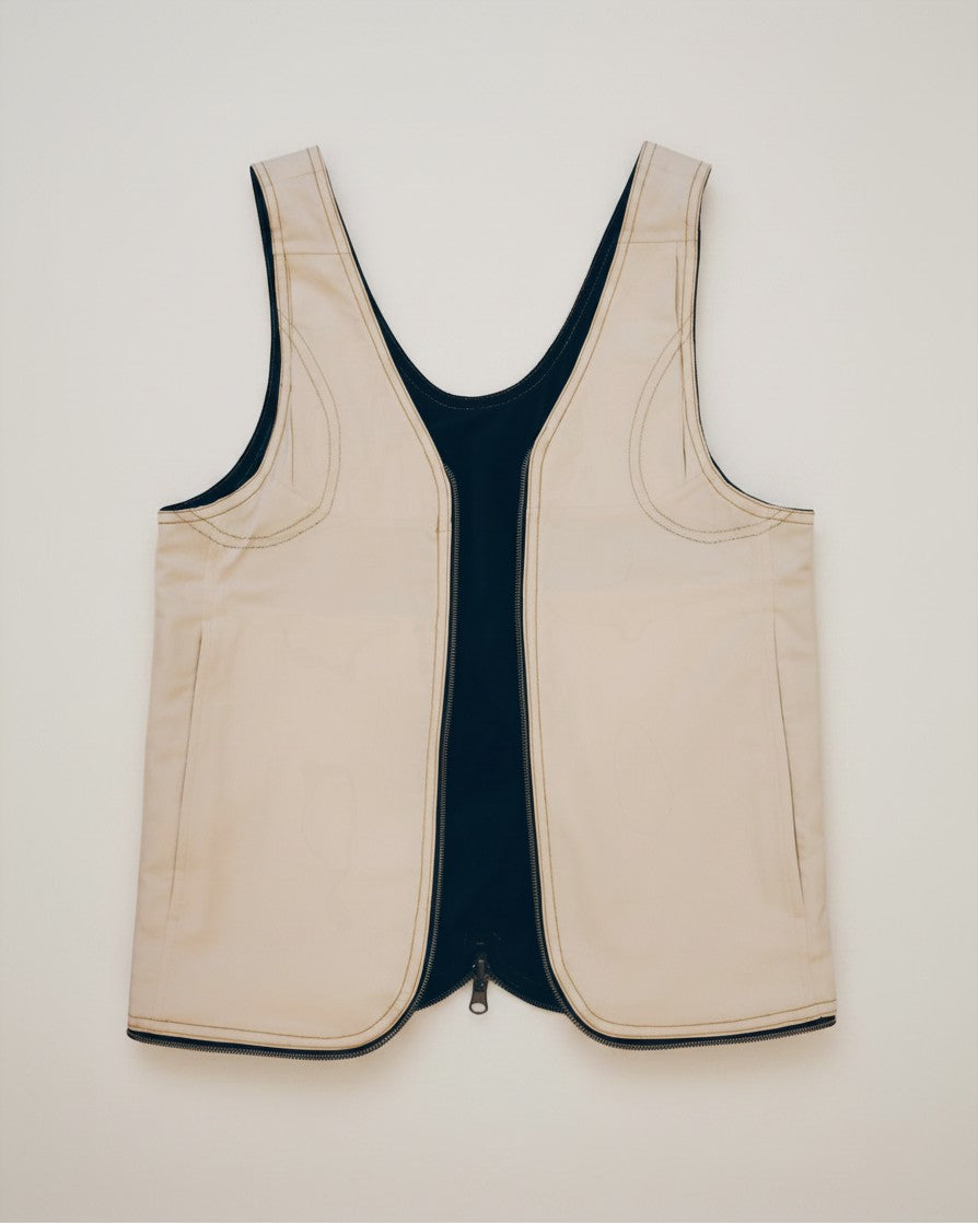 Hue Labs reversible white and black vest bag made from upcycled materials with a silver metal zipper.