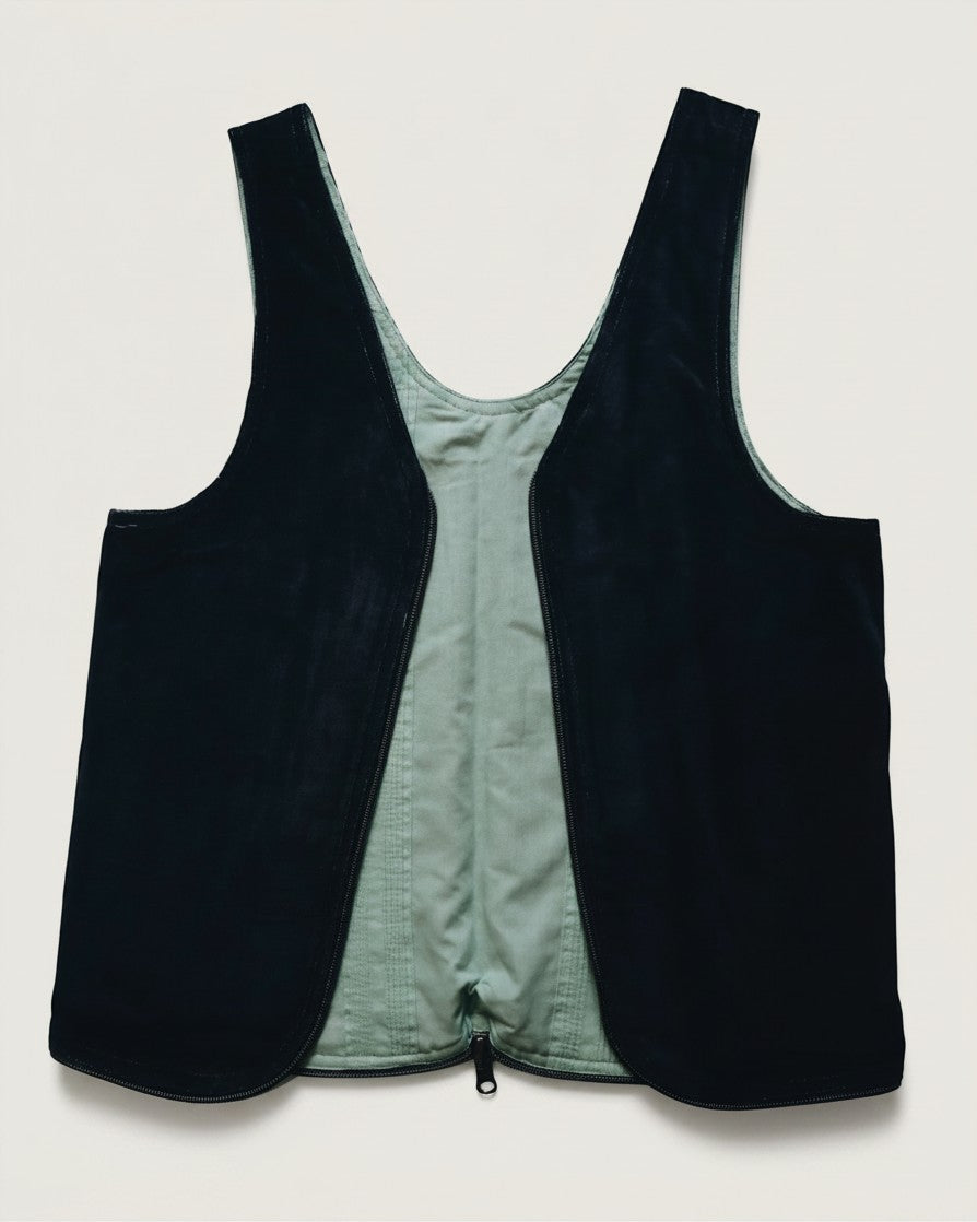 Hue Labs reversible vest bag in dark navy and sage green, featuring a gun metal double-direction zipper.