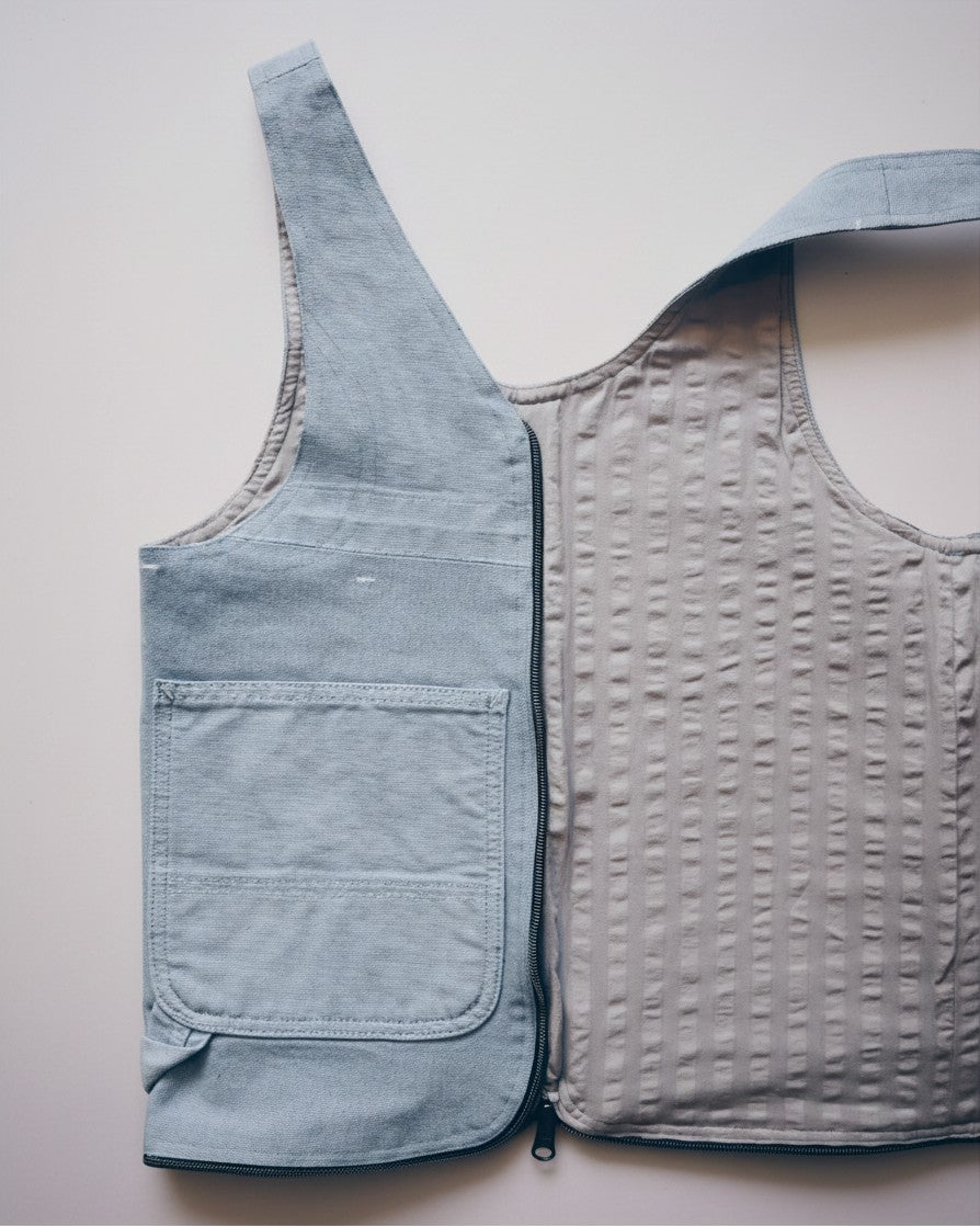 Hue Labs reversible baby blue vest bag made from upcycled fabric with a gun metal zipper and front pocket detail.
