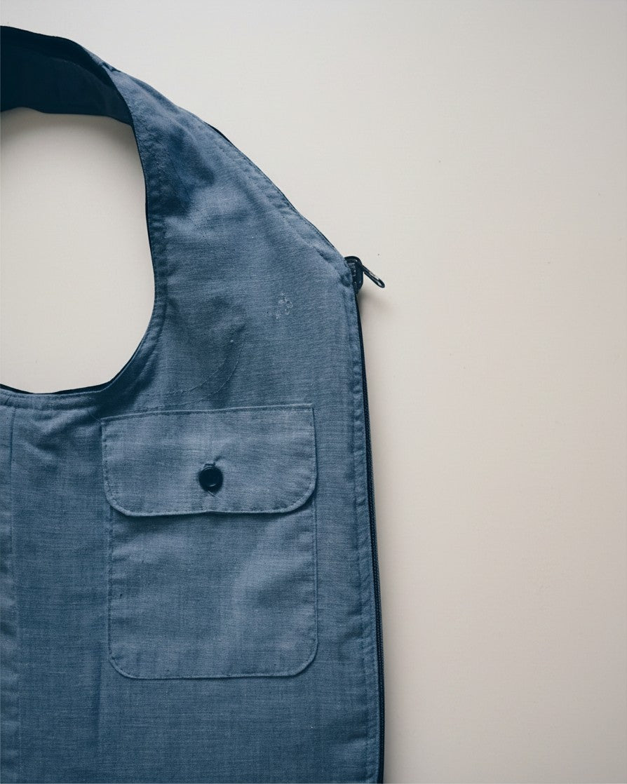 Hue Labs Sun Valley reversible vest bag in blue upcycled fabric with a front pocket and gun metal zipper detail