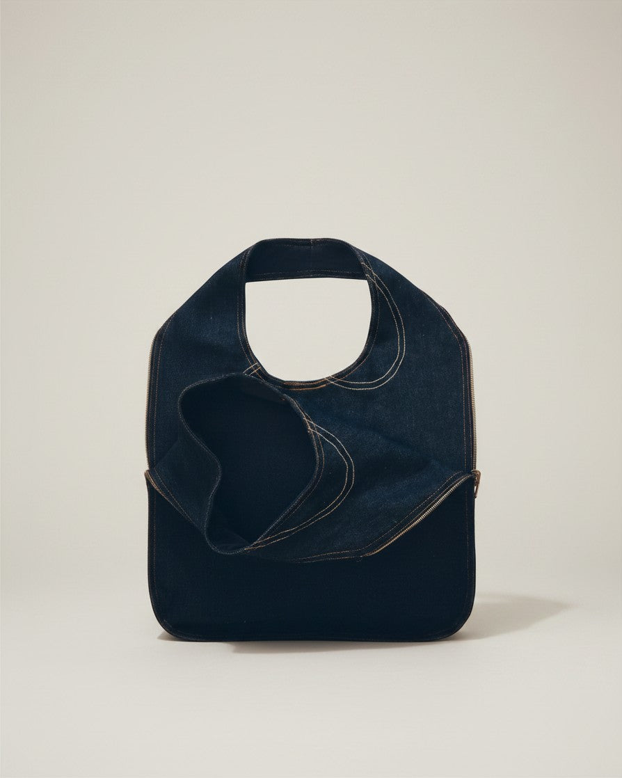 Hue Labs reversible blackout denim vest bag made from upcycled materials with silver metal zipper details.