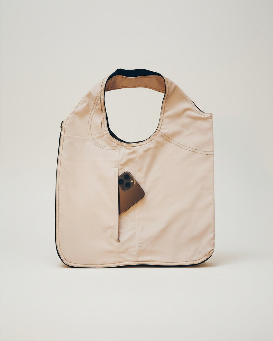 Hue Labs white steel vest bag, a reversible upcycled tote with a front pocket, shown against a neutral background.